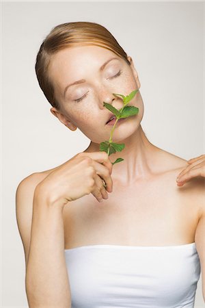 simsearch:632-07540029,k - Young woman enjoying fragrence of fresh mint leaves Stock Photo - Premium Royalty-Free, Code: 632-07161633