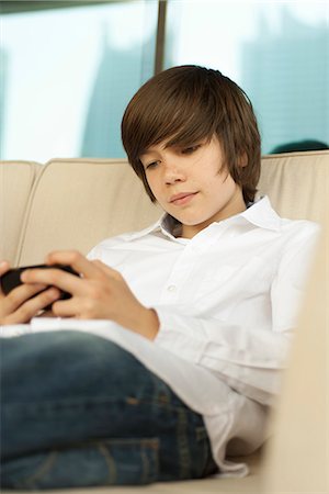 Teenage boy using smartphone Stock Photo - Premium Royalty-Free, Code: 632-07161652