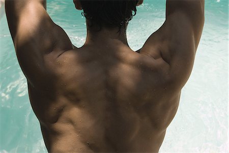 Man's muscular back, water in background Stock Photo - Premium Royalty-Free, Code: 632-07161661