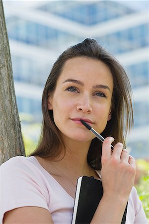 simsearch:614-06312057,k - Woman holding notebook and pen, looking up in thought Stock Photo - Premium Royalty-Free, Code: 632-07161677
