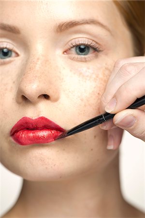 simsearch:6108-07969559,k - Young woman applying lip color, close-up Stockbilder - Premium RF Lizenzfrei, Bildnummer: 632-07494971