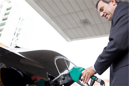 Businessman refueling car at gas station Stock Photo - Premium Royalty-Free, Code: 632-07494989