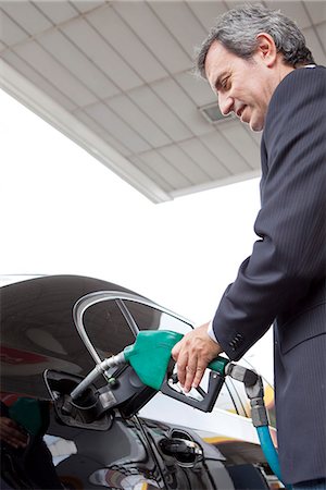 Businessman refueling car at gas station Stock Photo - Premium Royalty-Free, Code: 632-07494990