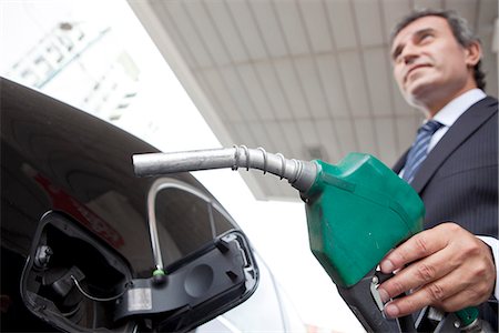 Businessman refueling car at gas station Stock Photo - Premium Royalty-Free, Code: 632-07494991