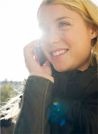 Young woman outdoors speaking on cell phone Stock Photo - Premium Royalty-Free, Code: 632-07539877