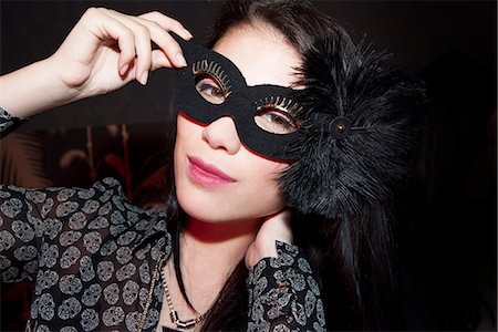 person holding up mask - Woman wearing party mask, portrait Stock Photo - Premium Royalty-Free, Code: 632-07539906