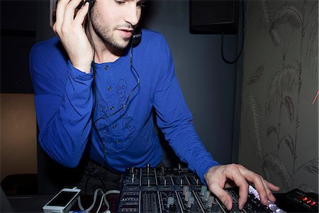 flash photography - DJ using audio mixer Stock Photo - Premium Royalty-Free, Code: 632-07539902