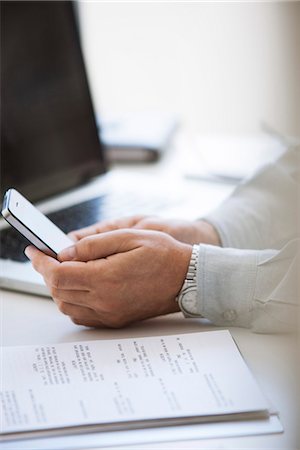 person on social media - Man using cell phone, cropped Stock Photo - Premium Royalty-Free, Code: 632-07539911