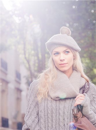 fashion women reflection - Woman wearing knit hat walking outdoors, portrait Stock Photo - Premium Royalty-Free, Code: 632-07539939