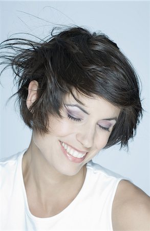 simsearch:632-07161489,k - Woman smiling, hair blowing Photographie de stock - Premium Libres de Droits, Code: 632-07539947