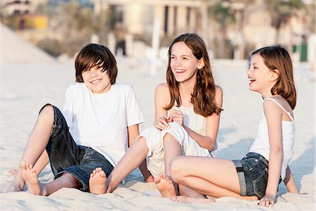 pre teen girl at the beach - Siblings sitting together on sand at the beach Stock Photo - Premium Royalty-Free, Code: 632-07539954