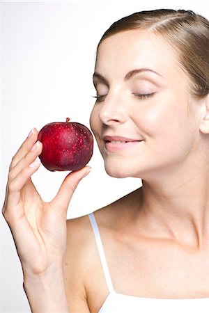 photography smelling fruit - Young woman with apple Stock Photo - Premium Royalty-Free, Code: 632-07539971