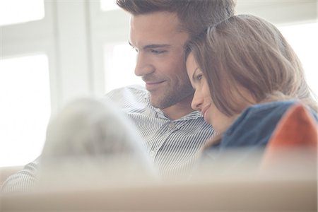 person watching side - Couple relaxing at home looking at laptop computer together Stock Photo - Premium Royalty-Free, Code: 632-07674519