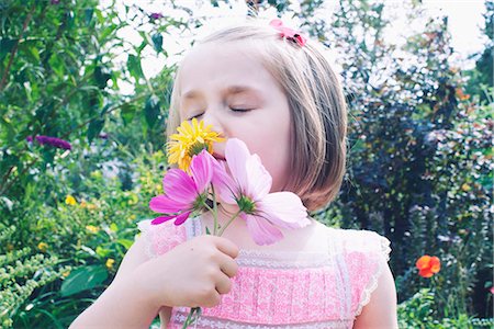 flower garden child - Little girl smelling flower Stock Photo - Premium Royalty-Free, Code: 632-07674536