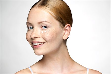 face smile - Young woman applying undereye cream Stock Photo - Premium Royalty-Free, Code: 632-07674608