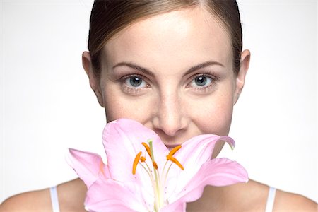 Young woman smelling orchid Foto de stock - Sin royalties Premium, Código: 632-07674631