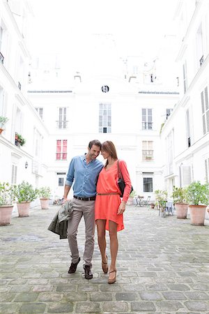 simsearch:851-02963141,k - Couple walking together in building courtyard Stock Photo - Premium Royalty-Free, Code: 632-07809297
