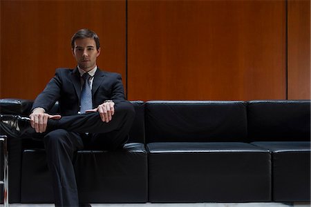 Businessman sitting in waiting room, portrait Stock Photo - Premium Royalty-Free, Code: 632-07809344