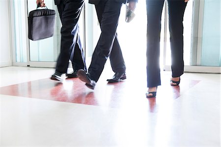 Business associates entering building together Stock Photo - Premium Royalty-Free, Code: 632-07809386