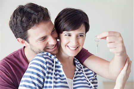 simsearch:632-06029993,k - Couple looking cheerfully at house key together Photographie de stock - Premium Libres de Droits, Code: 632-07809518