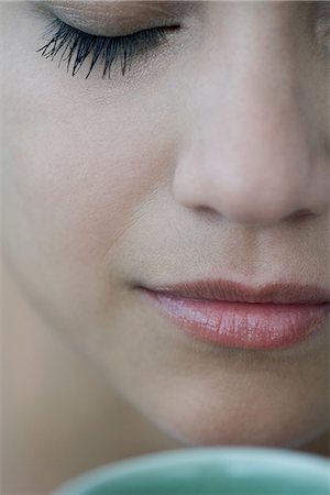 smelling (use the sense of smell) - Woman smelling hot drink, close-up Stock Photo - Premium Royalty-Free, Code: 632-07849511