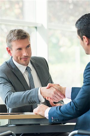 financial deal - Businessmen shaking hands in meeting Stock Photo - Premium Royalty-Free, Code: 632-08001602