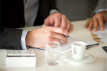 Businessman signing document Stock Photo - Premium Royalty-Free, Code: 632-08001824