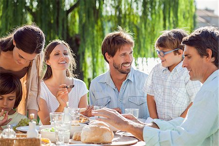 Family enjoying breakfast together outdoors Stock Photo - Premium Royalty-Free, Code: 632-08129729