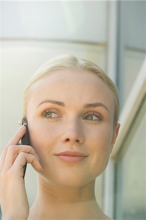 simsearch:632-08130262,k - Woman using cell phone, smiling Stock Photo - Premium Royalty-Free, Code: 632-08129723