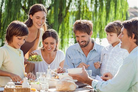 family and meal - Family enjoying breakfast together outdoors Stock Photo - Premium Royalty-Free, Code: 632-08129730