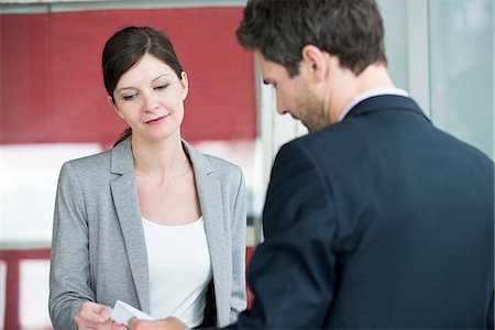 Hotel reception staff providing bill to guest Stock Photo - Premium Royalty-Free, Code: 632-08129754