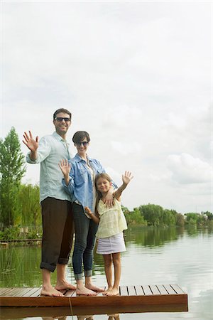 parents river - Family standing on dock waving Stock Photo - Premium Royalty-Free, Code: 632-08129818