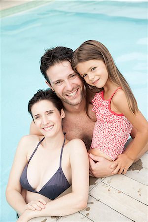 swimming girls in water - Family relaxing together in pool, portrait Stock Photo - Premium Royalty-Free, Code: 632-08129884