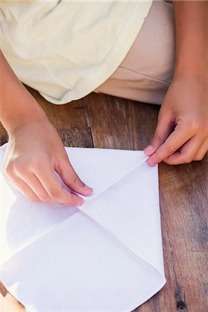 folding - Child folding paper, cropped Stock Photo - Premium Royalty-Free, Code: 632-08129914