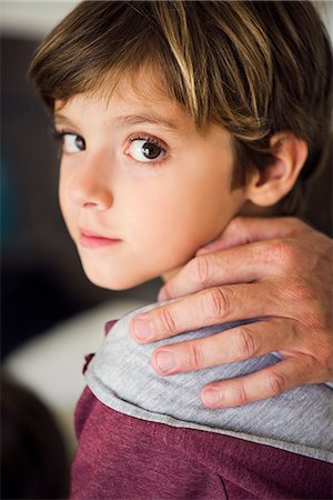 portrait parent - Parent's hand on boy's shoulder, cropped Stock Photo - Premium Royalty-Free, Code: 632-08129913