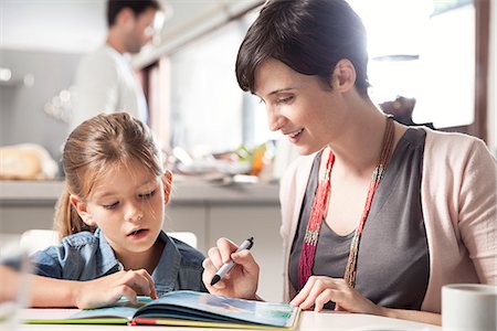 dad helping child - Mother and young daughter reading together Stock Photo - Premium Royalty-Free, Code: 632-08129922