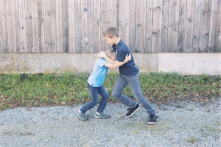 play with friends - Brothers rough housing outdoors Stock Photo - Premium Royalty-Free, Code: 632-08130098