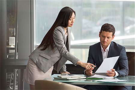 Business associates collaborating on document Stock Photo - Premium Royalty-Free, Code: 632-08130196