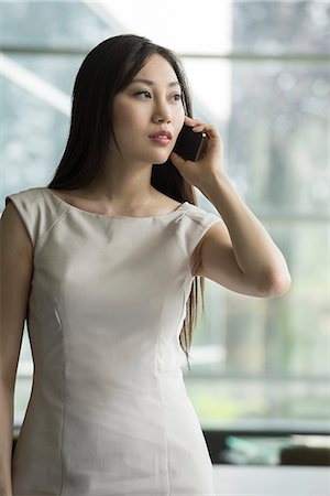 simsearch:632-08130262,k - Woman using cell phone Stock Photo - Premium Royalty-Free, Code: 632-08130292
