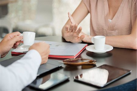 electronics smart phone tablet - Colleagues having informal meeting in cafe, cropped Stock Photo - Premium Royalty-Free, Code: 632-08130389