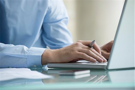 Man using laptop computer Stock Photo - Premium Royalty-Free, Code: 632-08227392