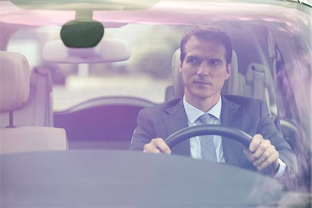 people driving not smiling not happy - Man driving car without passengers Stock Photo - Premium Royalty-Free, Code: 632-08227413