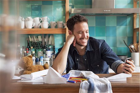 dad in kitchen - Man at home using smartphone Stock Photo - Premium Royalty-Free, Code: 632-08227493