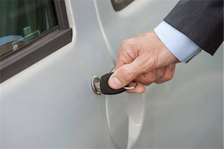 Man unlocking car door with key, cropped Stock Photo - Premium Royalty-Free, Code: 632-08227542