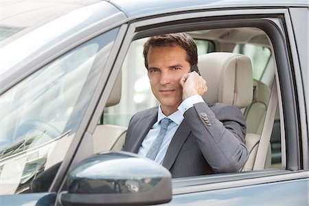 driving car on cell phone - Businessman using cell phone while driving car Stock Photo - Premium Royalty-Free, Code: 632-08227605