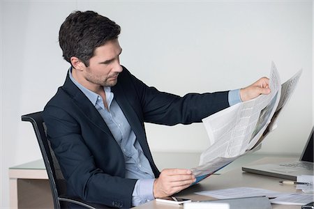 simsearch:632-08227744,k - Businessman reading newspaper in office Stock Photo - Premium Royalty-Free, Code: 632-08227628