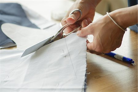 sewing material - Woman cutting fabric, cropped Stock Photo - Premium Royalty-Free, Code: 632-08227695