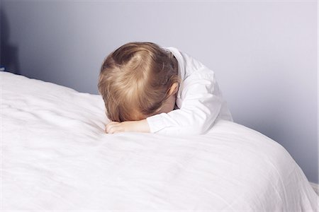 simsearch:632-05845347,k - Little boy resting head on bed Stock Photo - Premium Royalty-Free, Code: 632-08227800