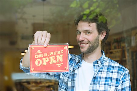 employee hold a sign - Businessman opening shop for business Stock Photo - Premium Royalty-Free, Code: 632-08331383