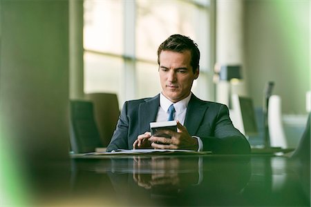 financial gain - Businessman using calculator Stock Photo - Premium Royalty-Free, Code: 632-08331682